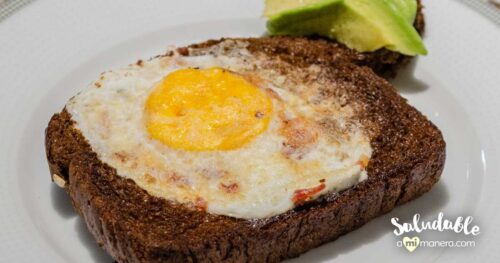 Huevos en canasta con pan de centeno y aguacate